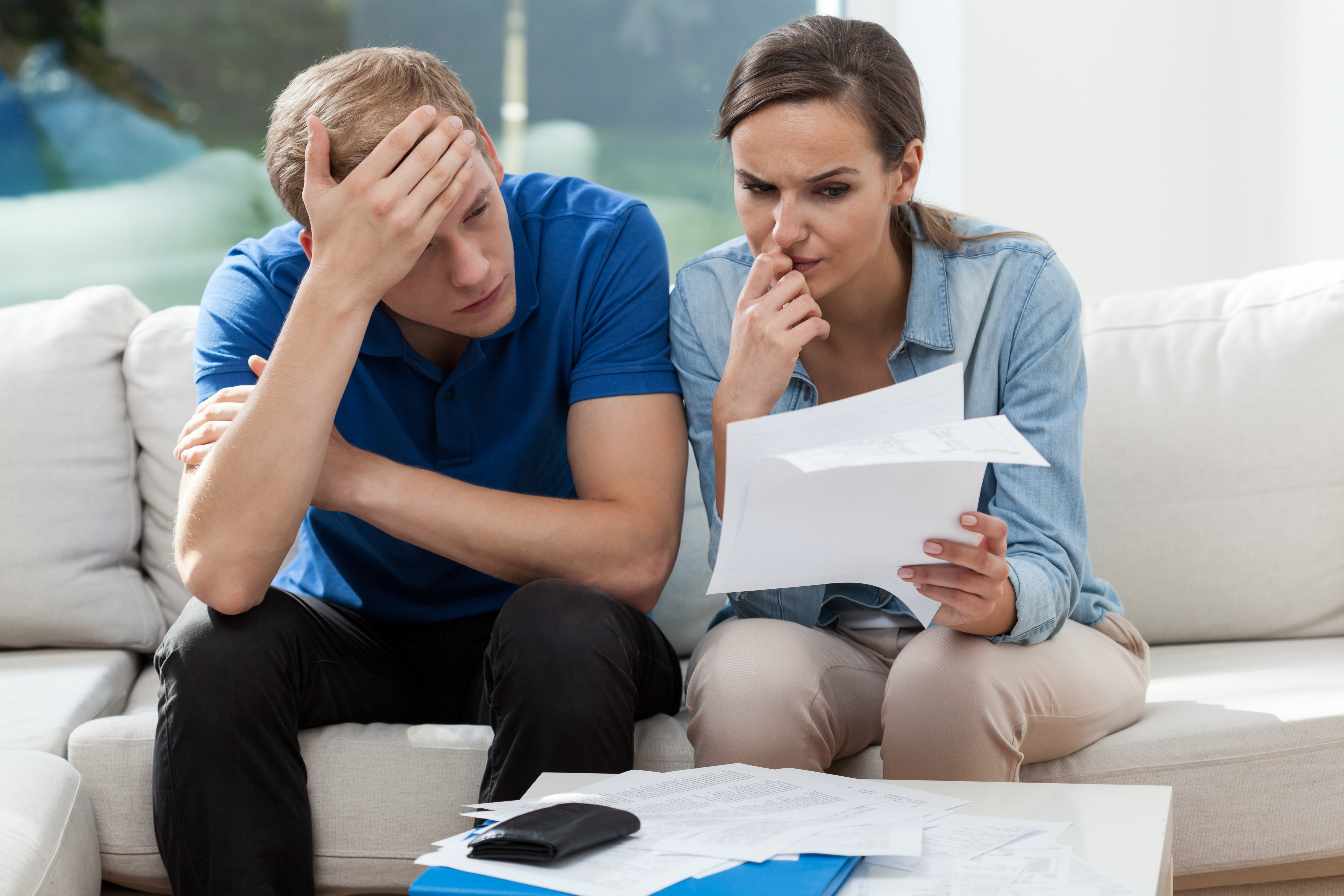 Horizontal view of couple analyzing family bills